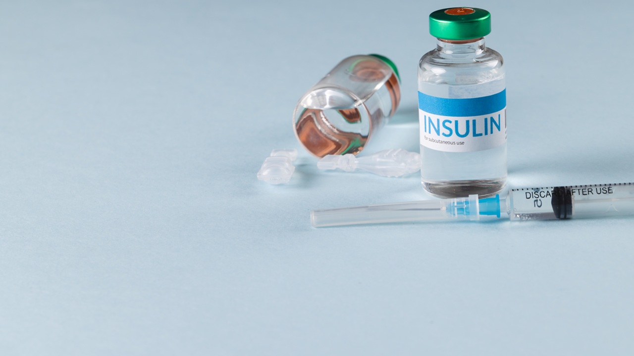 Insulin vial with syringe placed beside it.jpg