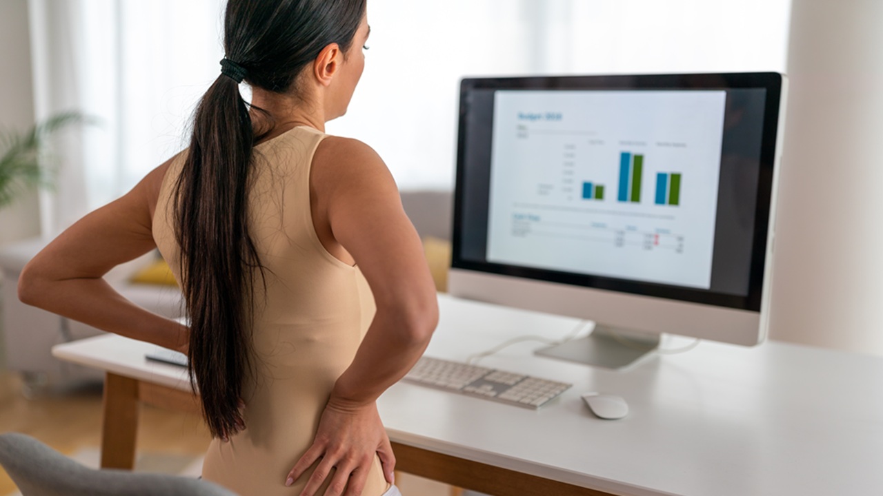 Remote worker with back pain caused by poor posture.jpg