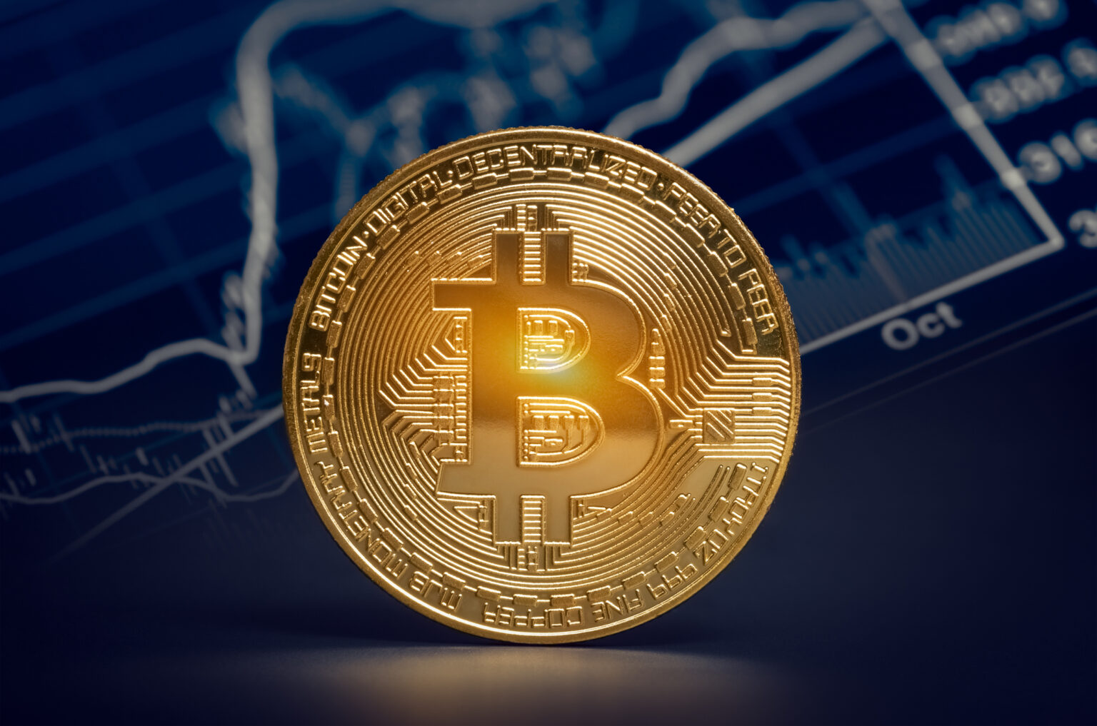 A gold coin with the bitcoin symbol on its face.jpg