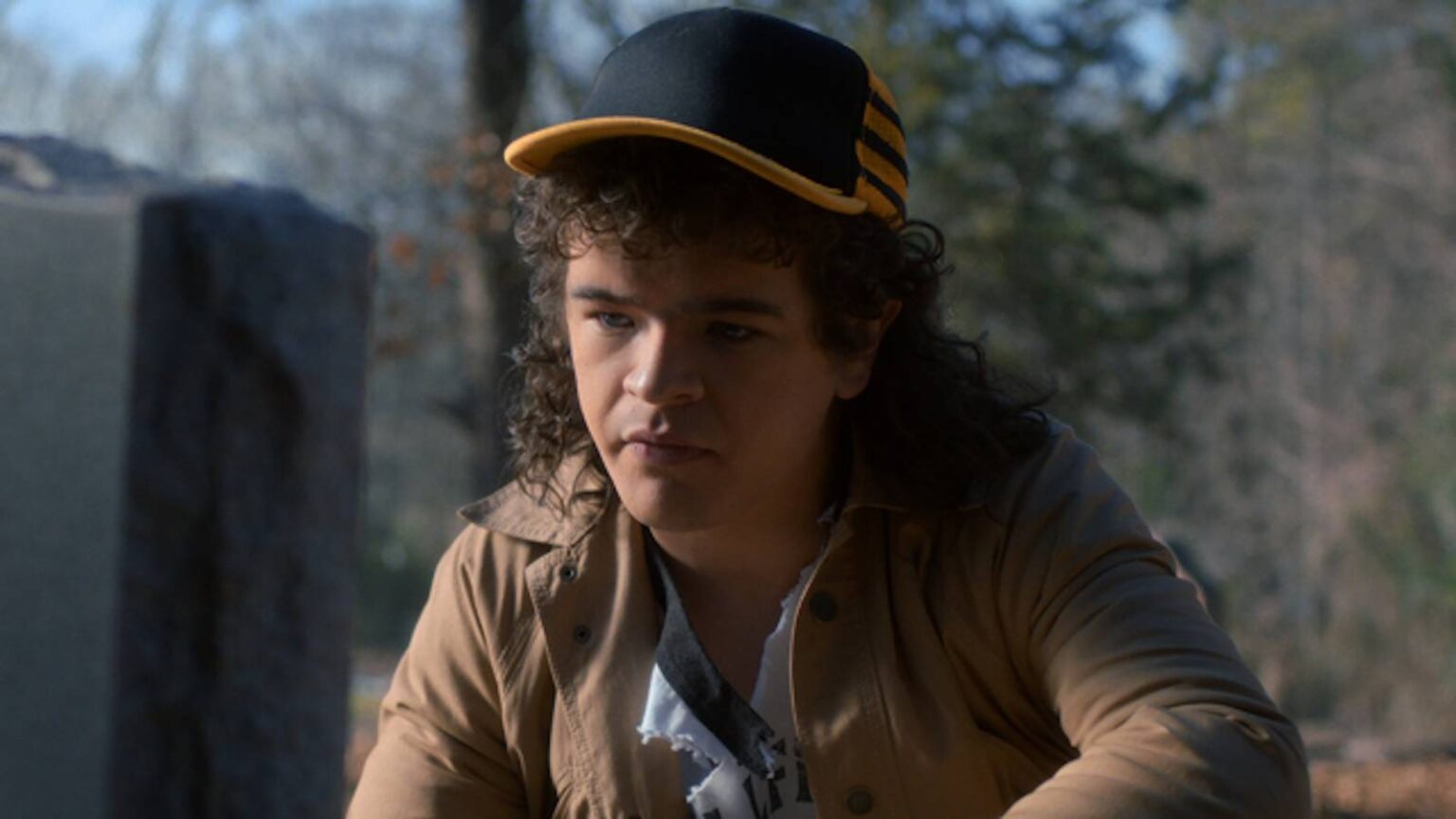 Gaten matarazzo s dustin kneels at a grave in stranger things season 5.jpg