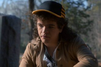 Gaten matarazzo s dustin kneels at a grave in stranger things season 5.jpg