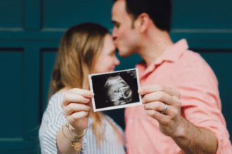 Man and woman holding an ultrasound image.png