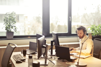 Man with headphones facing computer monitor.png