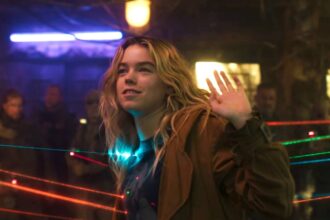 Milly alcock as supergirl with guns pointed at her.jpg