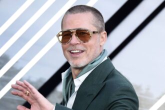 Brad pitt smiling and waving at the european premiere of f1.jpg