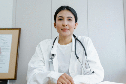 Woman in lab gown with stethoscope.png