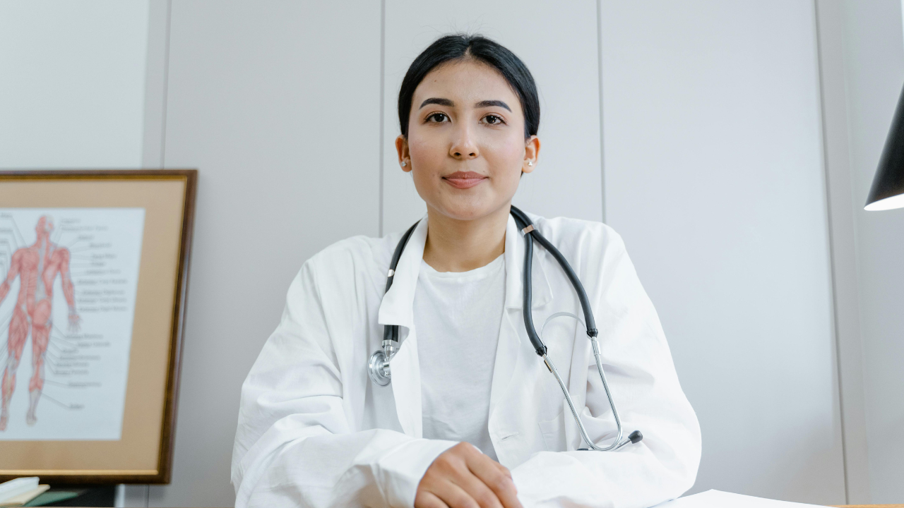Woman in lab gown with stethoscope.png