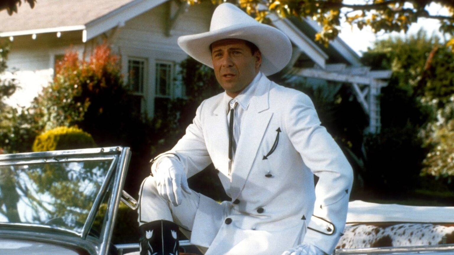 Bruce willis as tom mix dressed in a white cowboy outfit in sunset.jpg