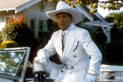 Bruce willis as tom mix dressed in a white cowboy outfit in sunset.jpg