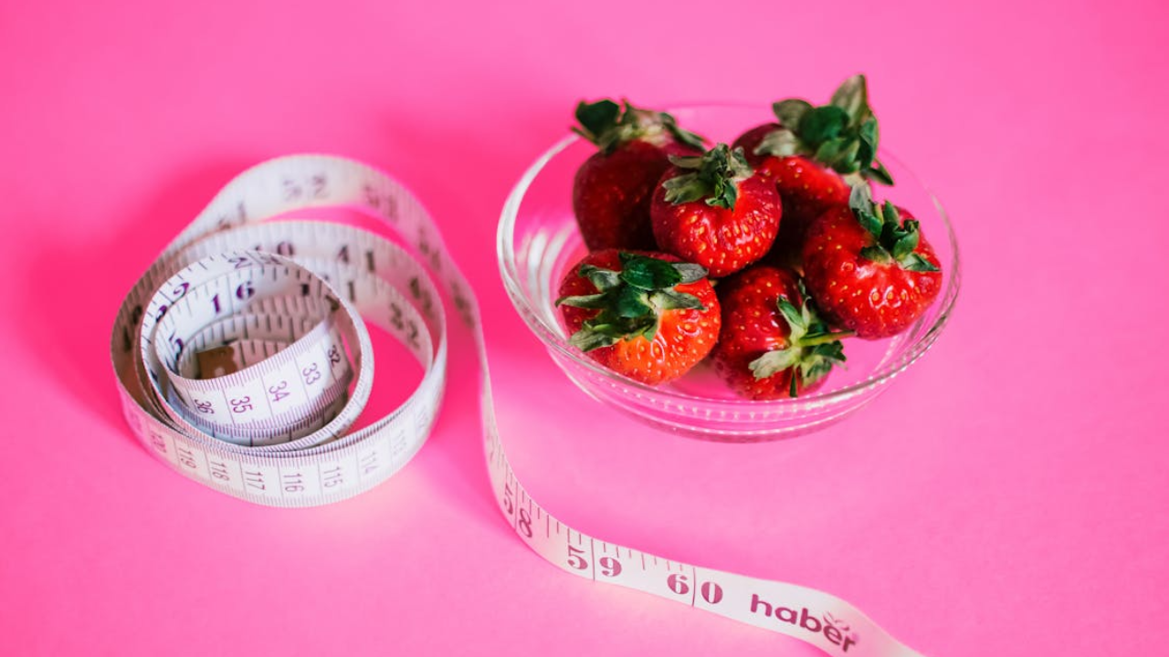 Healthy diet strawberries measuring tape.png