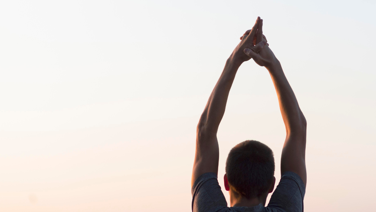 Man with hands air looking sky.png