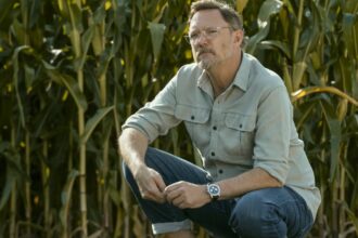 Matthew lillard crouches down in a field of corn in cross season 2.jpg