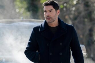 Tom ellis colin looking intense while standing in front of a car in cia.jpg