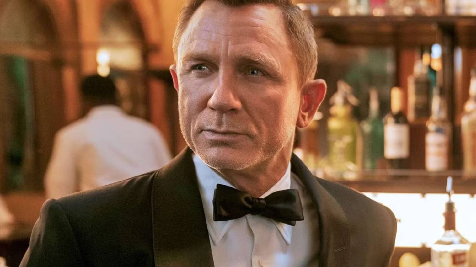 Daniel craig as james bond at a bar in no time to die.jpg