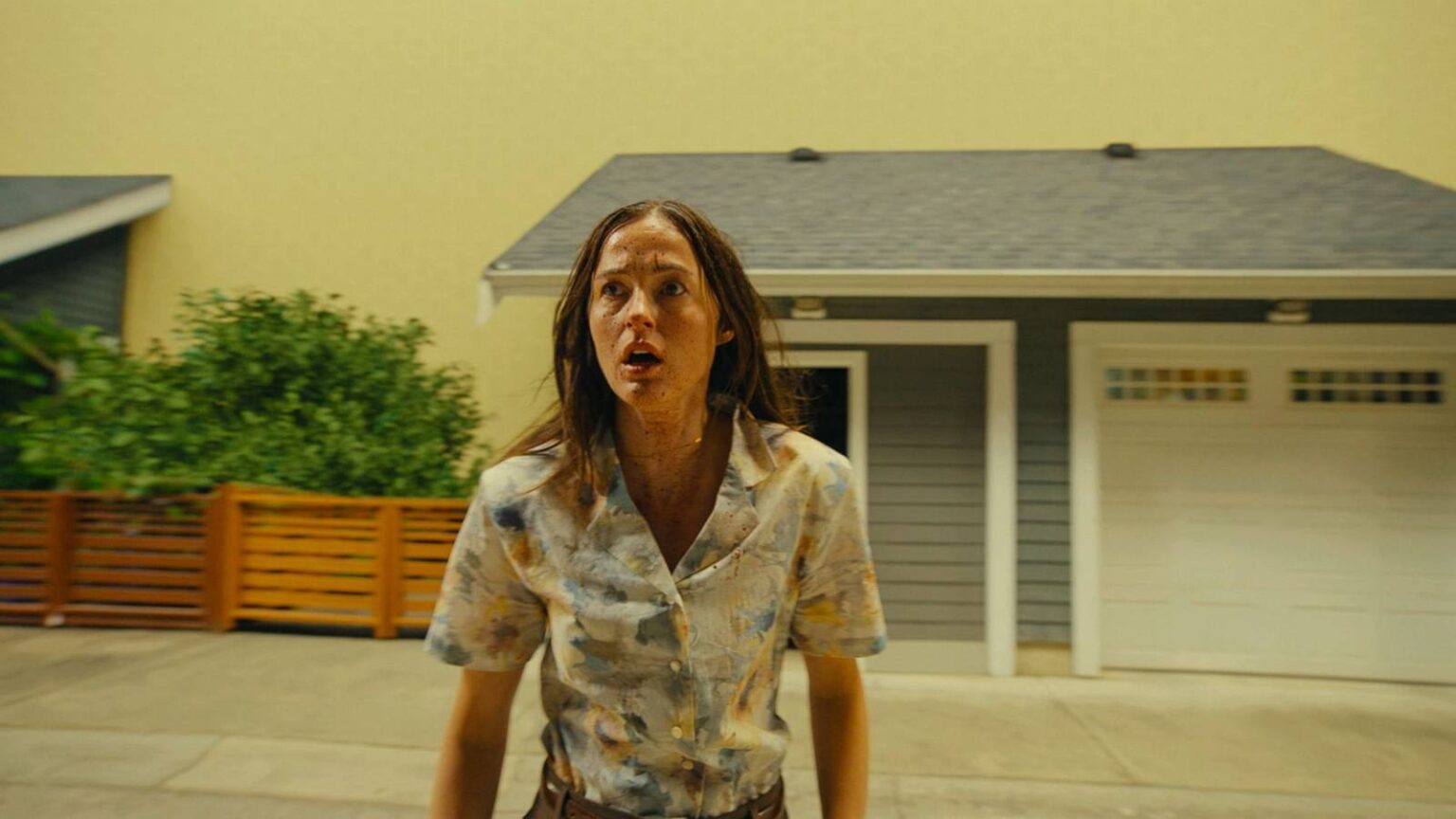 Renate reinsve covered in blood and running through a neighborhood in the backrooms movie.jpg