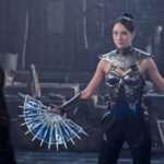 Kitana brandishing her blade fans against johnny cage in mortal kombat ii.jpg