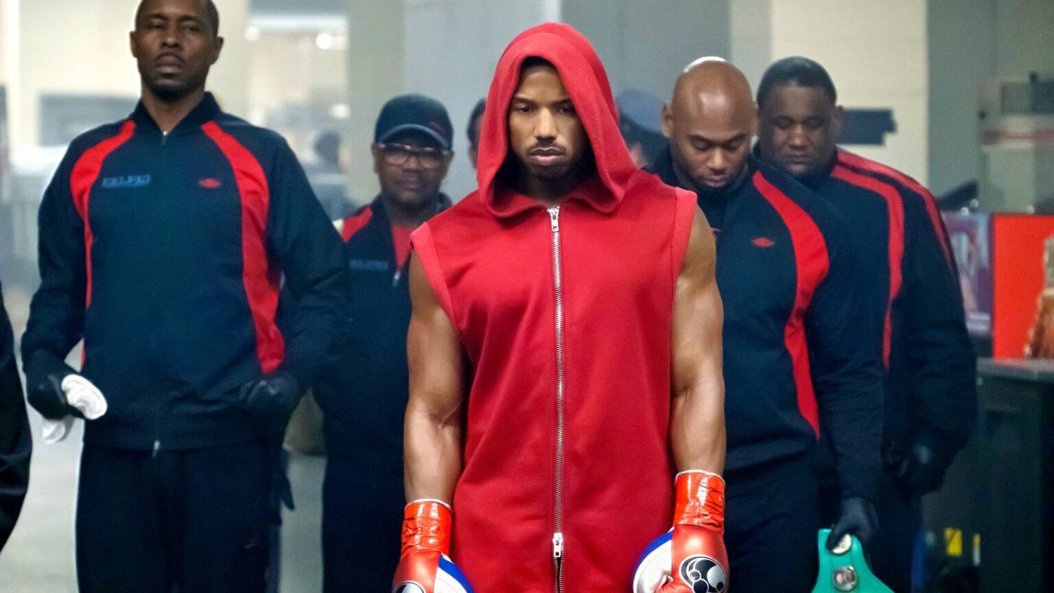 Michael b jordan looking glum in a red hoodie in creed 2.jpg